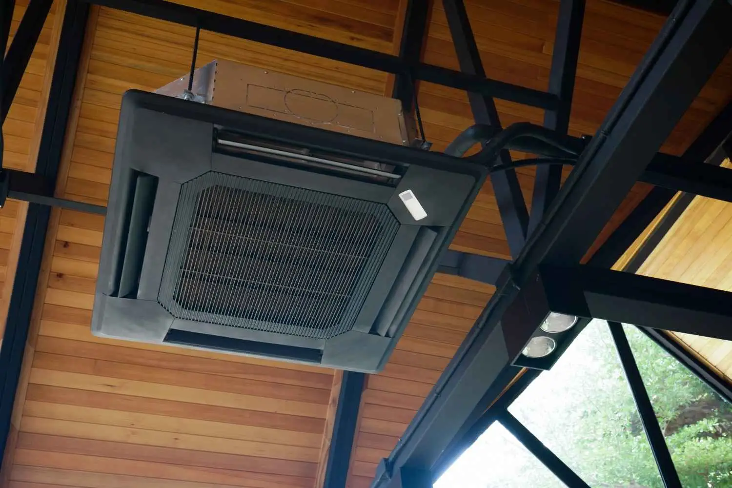A modern square black ceiling-mounted HVAC unit on a steel frame, serving as a mechanical example to answer: do air purifiers actually work? (benefits backed by the mechanism).