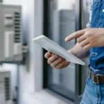 What acres home residents know humidity HVAC Functionality with HVAC technician inspecting air conditioning systems for optimal indoor comfort