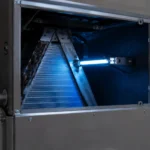 Installed HVAC ultraviolet lamp glowing blue near evaporator coils to evaluate are UV lights