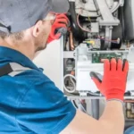 HVAC technician performing maintenance to demonstrate how to reset furnace safely