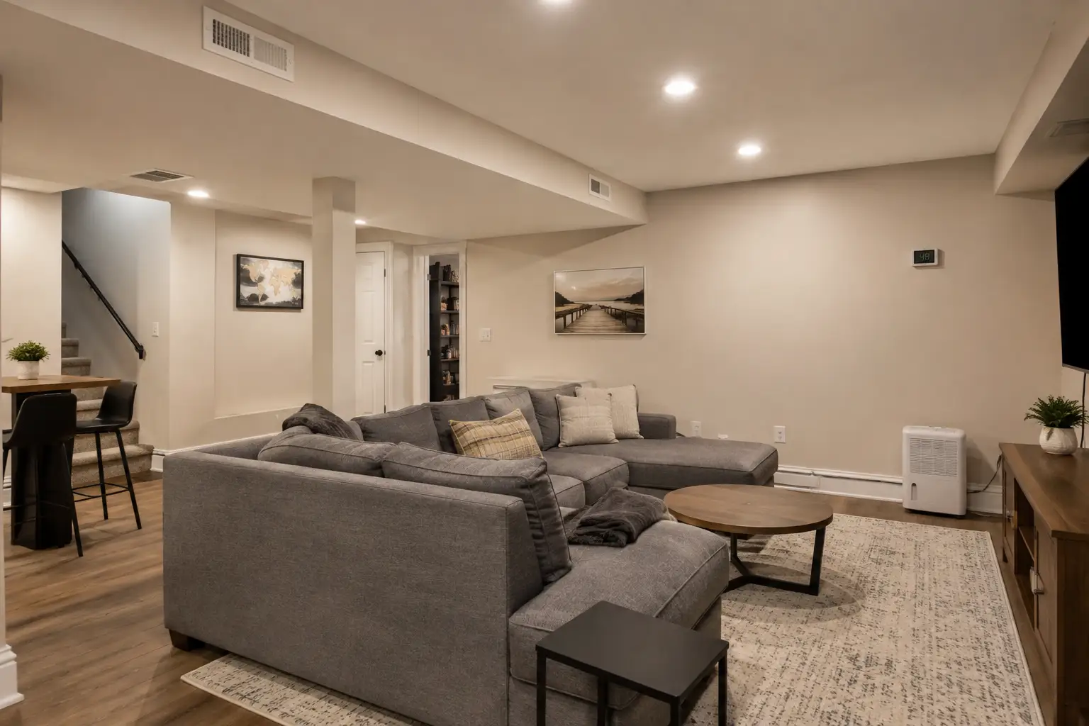 Modern finished living area showing ceiling HVAC supply vents installed to add a fresh-air intake.