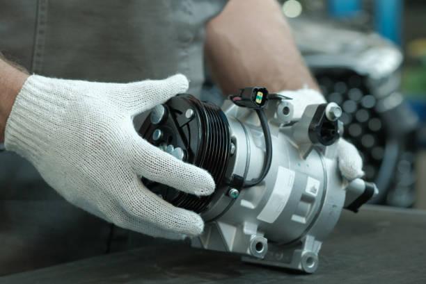 AC compressor being repaired by certified technician