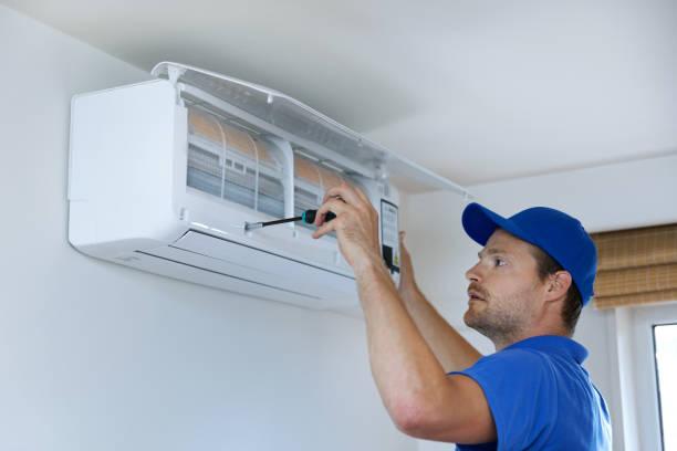 Houston homeowner reviewing AC service plan benefits with technician
