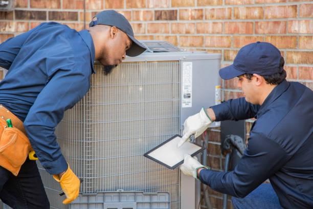 HVAC technician performing AC maintenance inspection
