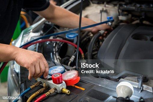 Technician diagnosing AC system failure