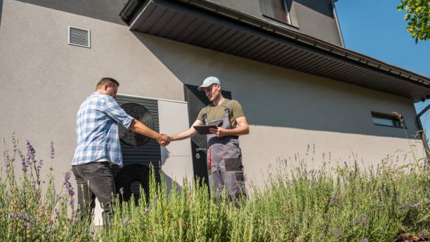 Technician discussing AC replacement options with homeowner