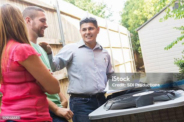 AC technician explaining repair costs to homeowner