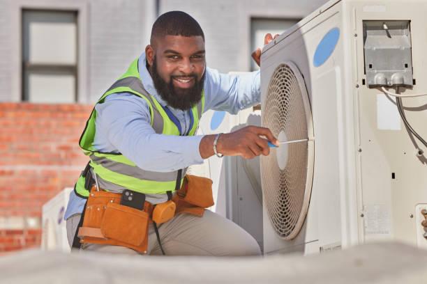 Professional HVAC technician performing AC tune-up in Houston home
