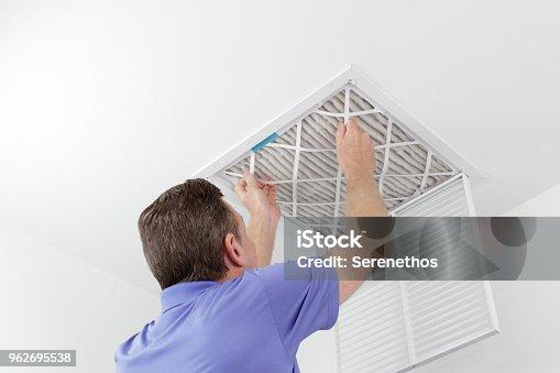 Homeowner Replacing AC Air Filter