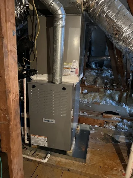 Gas furnace installed in basement with ductwork and vent pipes