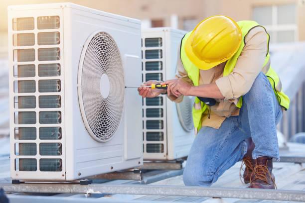 HVAC technician performing commercial AC maintenance in Houston