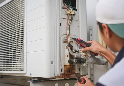 Close-up of Worker man fix air conditioning systems, Male technician service for repair and maintenance of air conditioners