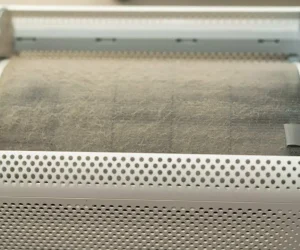A close-up of a heavily clogged, dusty air purifier barrel showing how does a HEPA filter work by