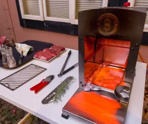 A high-heat tabletop infrared broiler glowing bright orange, used to demonstrate what is a furnace