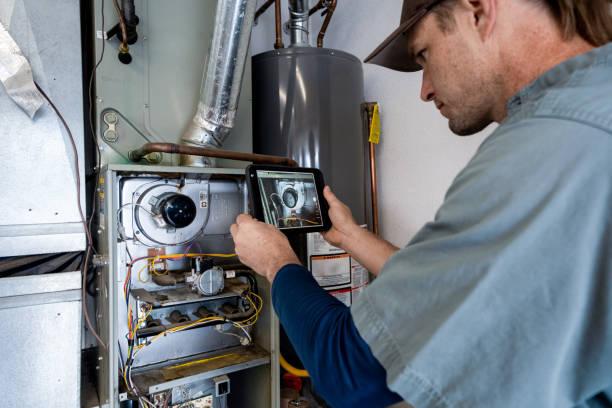 HVAC technician inspecting furnace blower motor