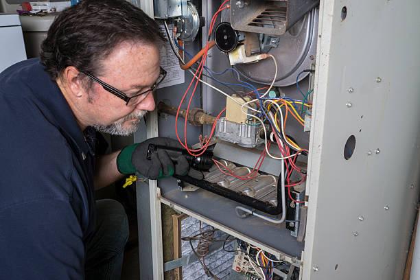 HVAC technician performing diagnostic testing on furnace
