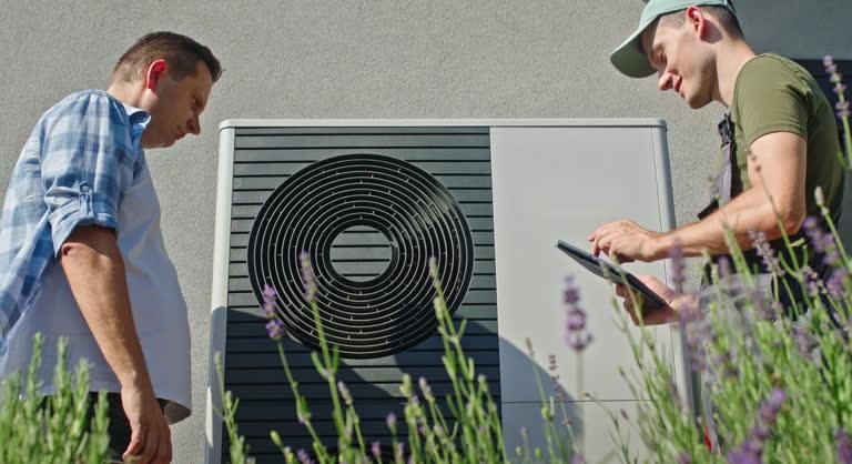 Homeowner reviewing and comparing HVAC company options