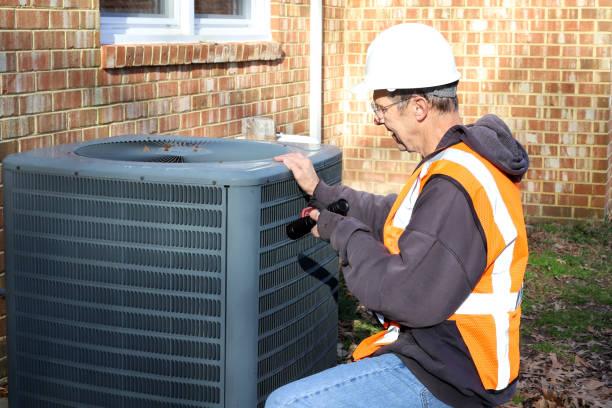 AC maintenance technician inspecting system in Houston home