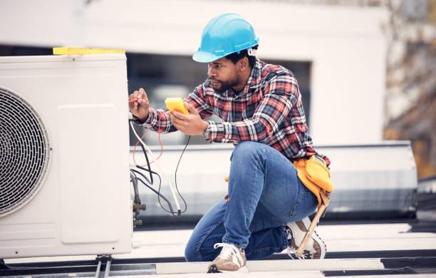 Professional AC technician performing preventative maintenance in Houston home