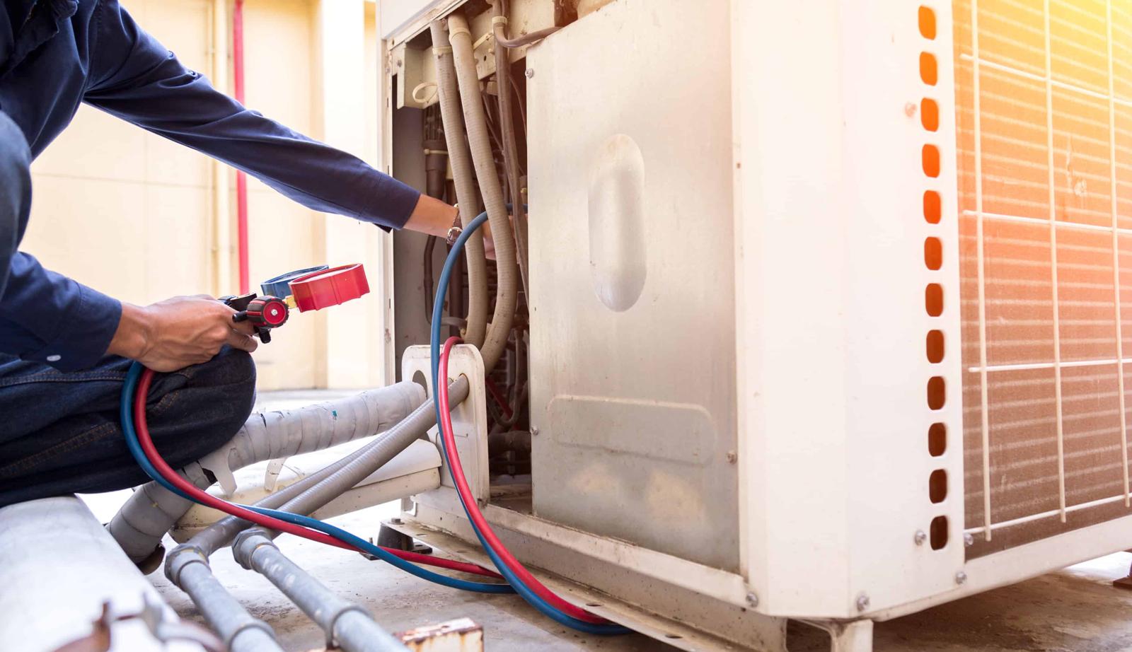 Professional HVAC technician diagnosing AC system issues in Houston home