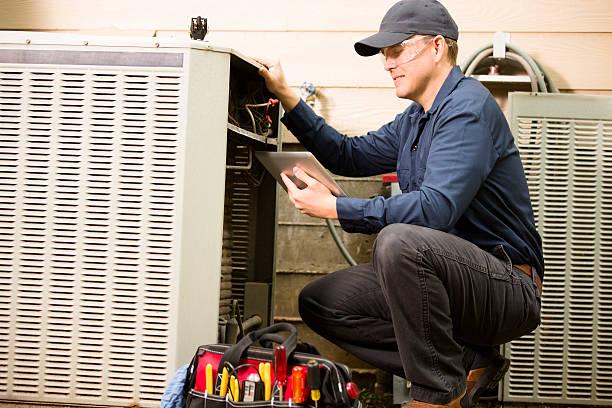 Professional AC technician servicing unit in Houston home