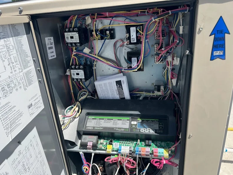 HVAC control panel with wiring and circuit board during inspection
