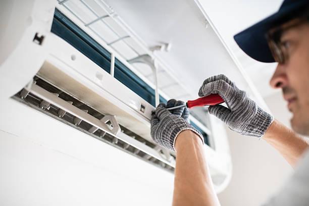 HVAC technician explaining repair options to homeowner