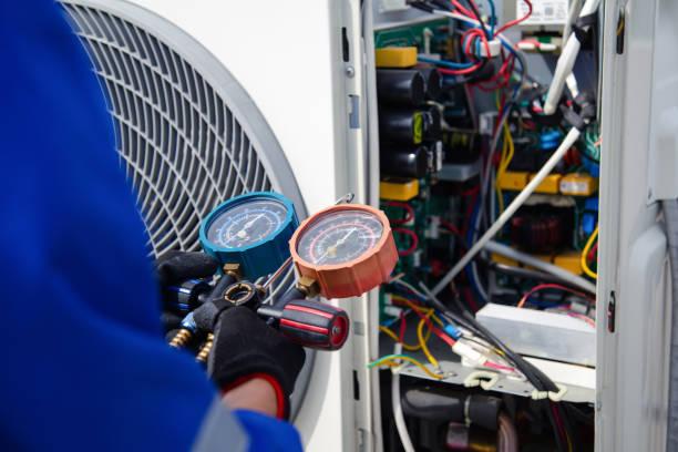 Professional HVAC technician performing AC tune-up service in Houston home
