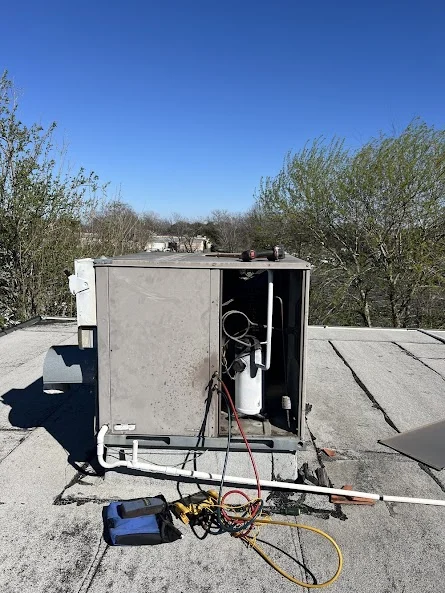 Rooftop HVAC unit connected to diagnostic equipment during testing