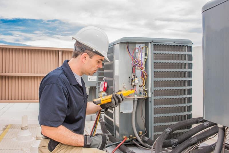 AC technician performing seasonal maintenance in Houston home